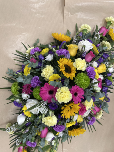 Colourful Memories Funeral Spray - A beautiful and vibrant funeral tribute, thoughtfully arranged with a stunning mix of bright, cheerful colours and soft, delicate tones. A heartfelt way to celebrate the life of a loved one, honour treasured memories and say a final goodbye with love and warmth.